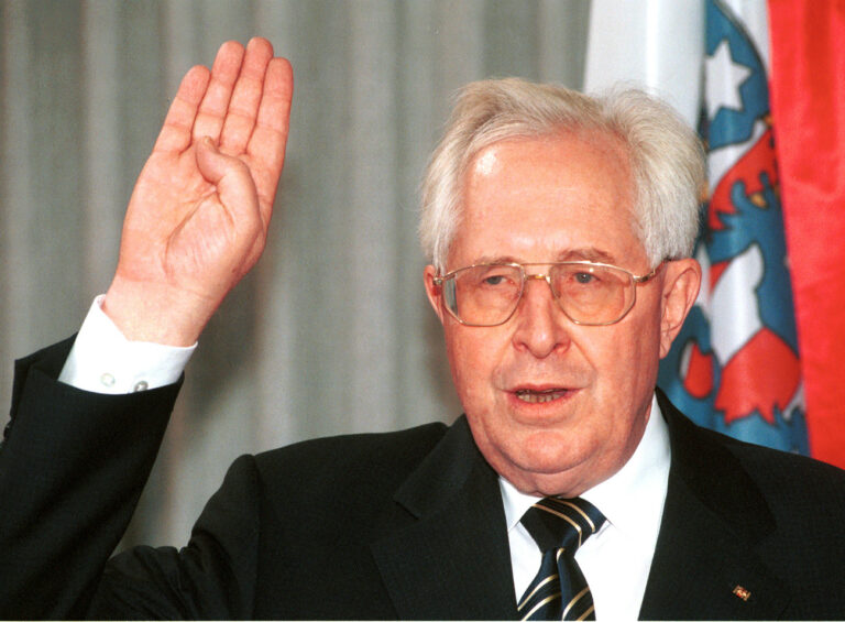 Thuringian state governor Bernhard Vogel is sworn in in front of Thuringia's flag in the state parliament in Erfurt, eastern Germany, in this October 1, 1999 picture. Germany's longest-serving state governor announced Saturday, May 24, 2003, that he will step down June 5, 2003 after 11 years in power. Vogel proposed 44-year-old Dieter Althaus as his successor. (AP Photo/Jens Meyer)