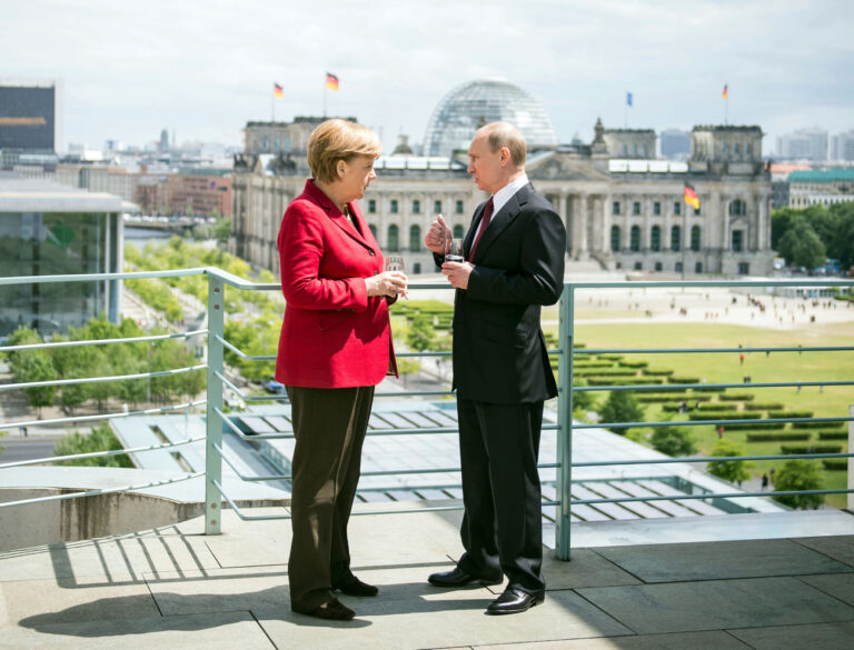 In this photo provided by German government German Chancellor Angela Merkel and Russia's President Vladimir Putin, from left, have a drink at the chancellery in Berlin, Germany, Friday, June 1, 2012. Building in the background is the Reichstag that hosts the German parliament Bundestag. (AP Photo, Bundesregierung, Guido Bergmann)