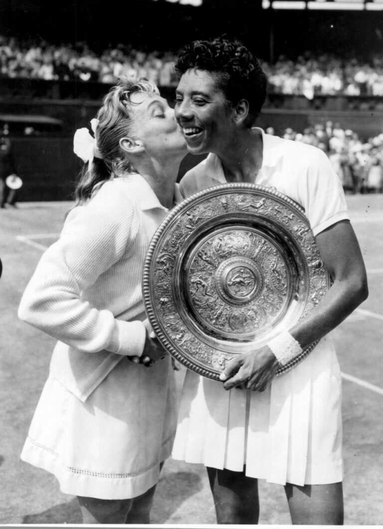 Miss Darlene Hard USA kisses Althea Gibson USA after Gibson beat her in the womens singles finals at Wimbledon. She was the first black women to win the title Her Majesty the Queen presented the trophy..6th July 1957 (KEYSTONE/UNITED ARCHIVES)