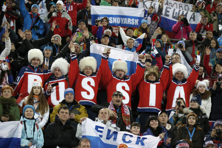 Russian fans cheer during the flower ceremony of the women's 15km individual biathlon competition at the XXII Winter Olympics 2014 Sochi in Krasnaya Polyana, Russia, on Friday, February 14, 2014. (KEYSTONE/Peter Klaunzer)