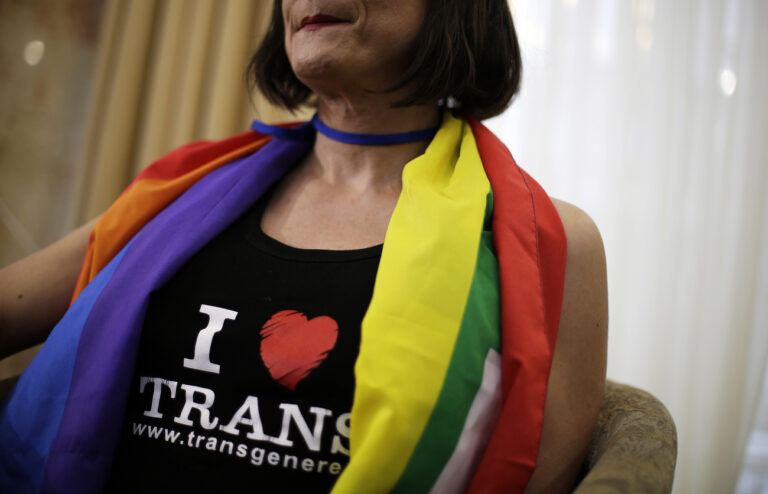 Vladimir Luxuria, a former Communist lawmaker in the Italian parliament and prominent crusader for transgender rights, wears a pro-transgender t-shirt as she sits for an interview, Monday, Feb. 17, 2014, in central Sochi, Russia, home of the 2014 Winter Olympics. Luxuria said she was detained by police at the Olympics after being stopped while carrying a rainbow flag that read in Russian: 