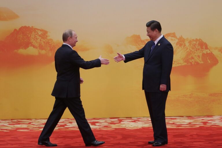 epa04484784 A picture made available on 11 November 2014 shows Russian President Vladimir Putin (L) shaking hands with Chinese President Xi Jinping (R) before the APEC economic leaders meeting in Beijing, China, 10 November 2014. The Asia-Pacific Economic Cooperation (APEC) is an inter-governmental forum that seeks to promote sustainable growth and economic integration, and reduce trade barriers across the Asia-Pacific region. EPA/MIKHAIL METZEL/RIA NOVOSTI/ POOL MANDATORY CREDIT