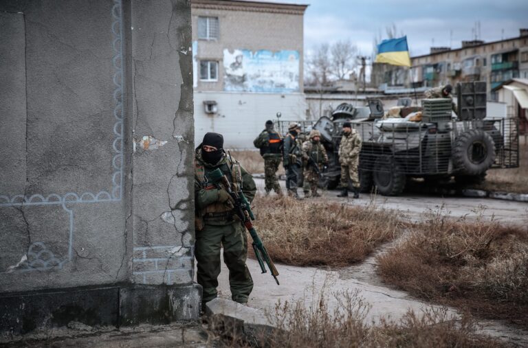 epa04539504 A Ukrainian soldier takes up a position in the eastern city of Debaltseve, Ukraine, 24 December 2014. The Ukraine Contact Group was meeting in Belarus with representatives aiming to restart peace talks between the government and pro-Russian rebels three months after they agreed to a ceasefire. The trilateral Contact Group consists of Russia, Ukraine and the Organisation for Security and Cooperation in Europe (OSCE). EPA/ROMAN PILIPEY