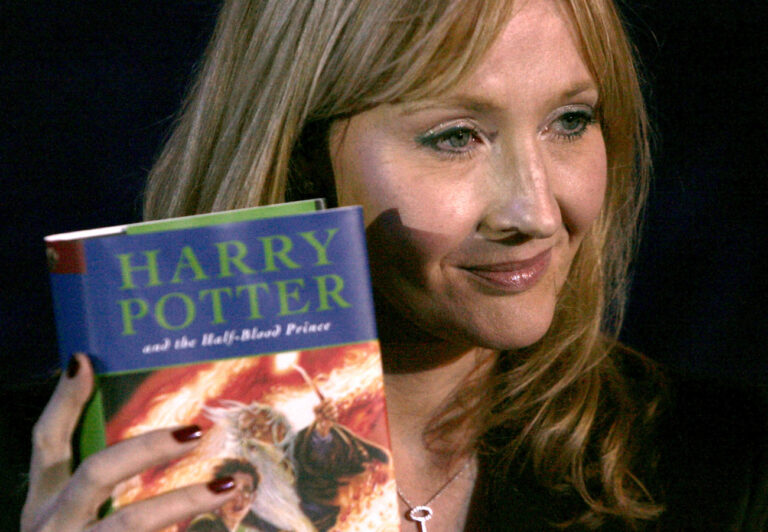 British author J.K. Rowling holds a copy of her latest book 'Harry Potter and the Half-Blood Prince' as she arrives at Edinburgh Castle in Edinburgh, Scotland, to give a book reading to 70 children for its world wide launch, Friday, July 15, 2005. The sixth book in the seven-book series, is to be released at a minute after midnight. (KEYSTONE/AP Photo/Matt Dunham)