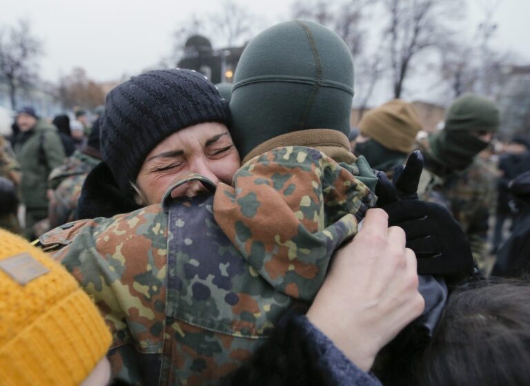 epa04565209 A volunteer of the 'Azov' battalion says his goodbyes during a ceremony before being sent to eastern Ukraine, near of St. Michael Cathedral in Kiev, Ukraine, 17 January 2015. Five people have been killed in clashes between government troops and Russia-backed separatists in eastern Ukraine, the army and rebels said, one day after fighting for control of Donetsk airport prompted the cancellation of peace talks. The Ukrainian army said three of its soldiers were killed. Rebels reported also two civilian casualties. EPA/SERGEY DOLZHENKO
