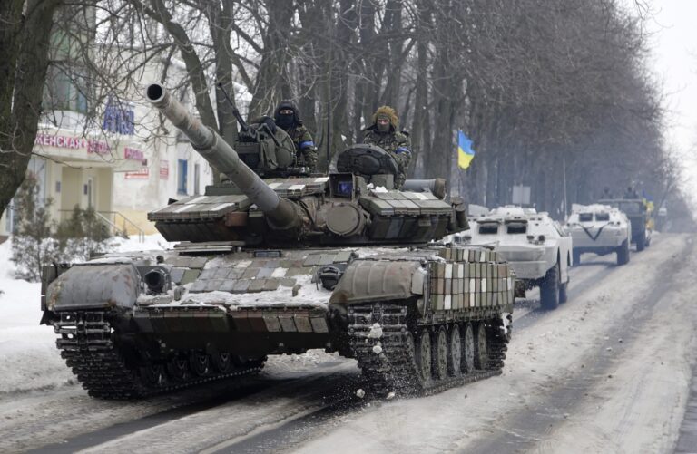 epa04566918 A column of Ukrainian forces vehicles drive in a convoy in Volnovakha city, Ukraine, 18 January 2015. In the worst incident in recent months, 12 civilians were killed and 18 injured when an artillery shell hit a bus in the eastern Donetsk region on 13 January, local authorities said. The bus was standing at a Ukrainian army checkpoint near the town of Volnovakha when it was hit by a shell fired from pro-Russian separatists, the Kiev-loyal regional government said in a statement. EPA/ALEXANDER ERMOCHENKO EPA/ALEXANDER ERMOCHENKO