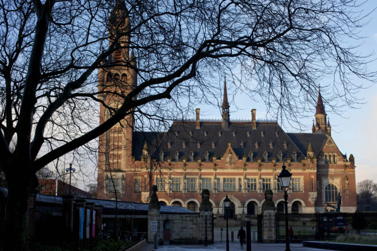 A man walks towards the International Court of Justice in The Hague, Netherlands Tuesday, Feb. 3, 2015. The World Court is expected to hand down a judgement Tuesday on charges of genocide brought by Croatia and Serbia against each other over atrocities committed during the disintegration of Yugoslavia. (AP Photo/Peter Dejong)