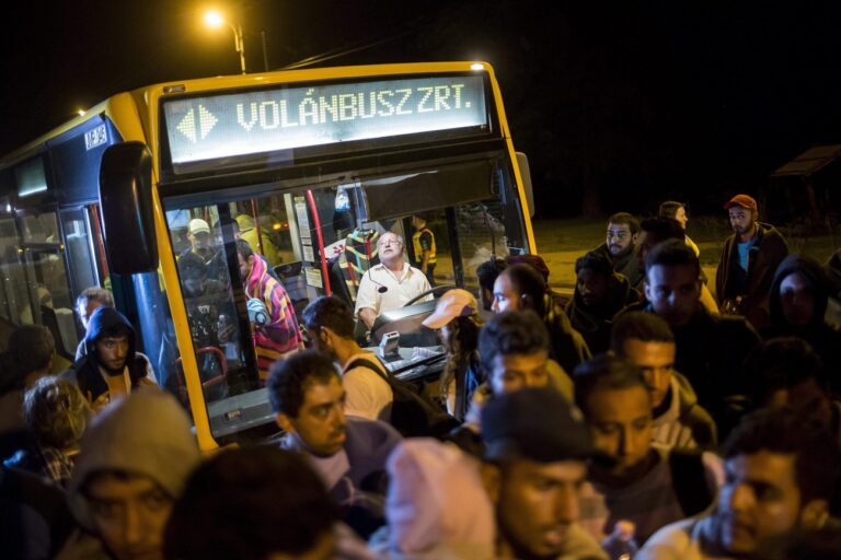 epa04914442 Refugees get off a bus at the former border station of Hegyeshalom, Hungary, 05 September 2015. Austrian police say they expect 10,000 arrivals out of Hungary now that Hungary has allowed migrants held up there to travel further west after they had suffered days of ordeal in Hungary. Many of them, mostly Syrian refugees, are presumed to immediately continue their journey onwards to Germany after receving initial care in Austria. EPA/BALAZS MOHAI HUNGARY OUT