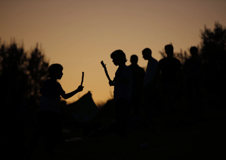 Children, mostly Syrians, trying to reach Europe play outside the Turkish city of Edirne, which borders European Union members Greece and Bulgaria, Wednesday, Sept. 16, 2015. Asylum-seekers wait for a second day near the border with Greece, hoping authorities would allow them to cross into Europe overland instead of them having to risk their lives by sea trying to reach Greek islands. (AP Photo/Emrah Gurel)