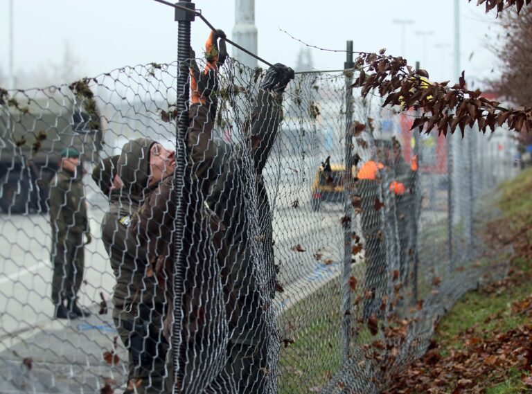 Austrian soldiers are building a fence to improve the procedure for arriving refugees at the border between Slovenian and Austria in Spielfeld, Austria, Tuesday, Dec. 8, 2015. (AP Photo/Ronald Zak)