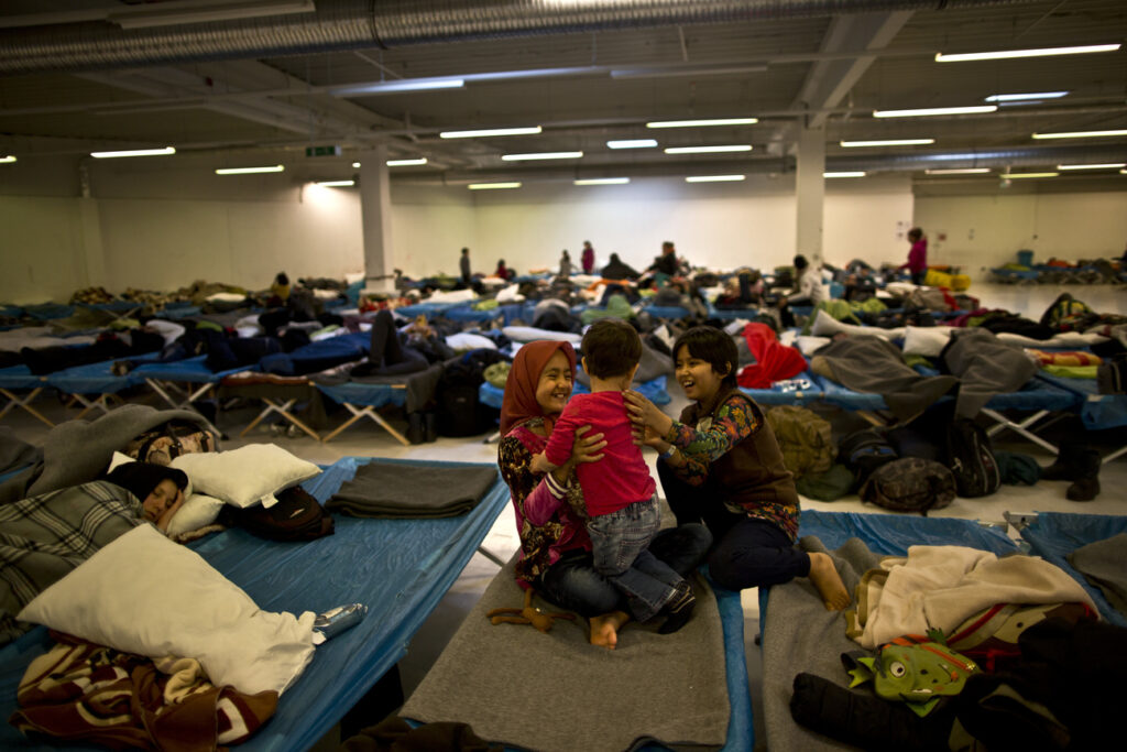 Afghan refugee children play at an assembly and distribution centre after arriving with their families from Austria, in Freilassing, Germany, Tuesday, Dec. 8, 2015. Six children drowned after a rubber dinghy carrying Afghan migrants to Greece sank off Turkey's Aegean coast. Turkey has stepped up efforts to stop migrants from leaving to Greece by sea. (AP Photo/Muhammed Muheisen)