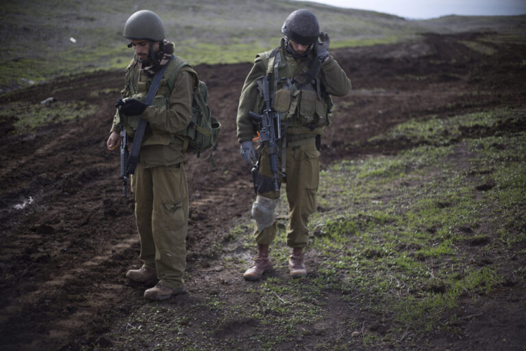 Israeli reserve soldiers from the 77 battalion of the 7th brigade from the armored corps check their gear during an exercise in the Israeli controlled Golan Heights, near the border with Syria, Monday, Jan. 11, 2016. (AP Photo/Ariel Schalit)