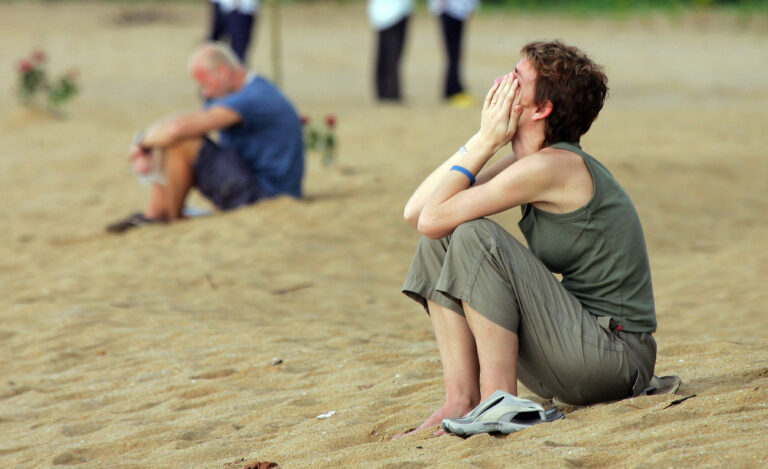 An unidentified woman weeps on the beach in Khao Lak, Thailand, just before the first anniversary ceremony for friends and family of Swedish Tsunami victims Monday, Dec. 26, 2005. More than 500 Swedes were killed in Thailand in last year's Tsunami. (KEYSTONE/AP Photo/David Longstreath)