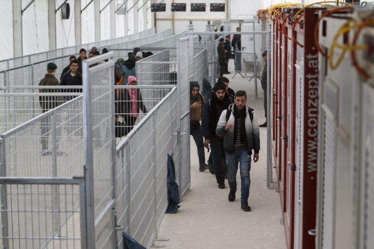 Migrants arrive to be registered in a tent of the reception center at the Austrian-Slovenian border crossing in Spielfeld, Austria, Monday, Feb. 8, 2016. (Gyorgy Varga/MTI via AP)