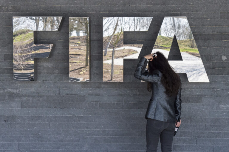 A journalist watch herself in the mirror of the FIFA Logo at the FIFA Headquarters 