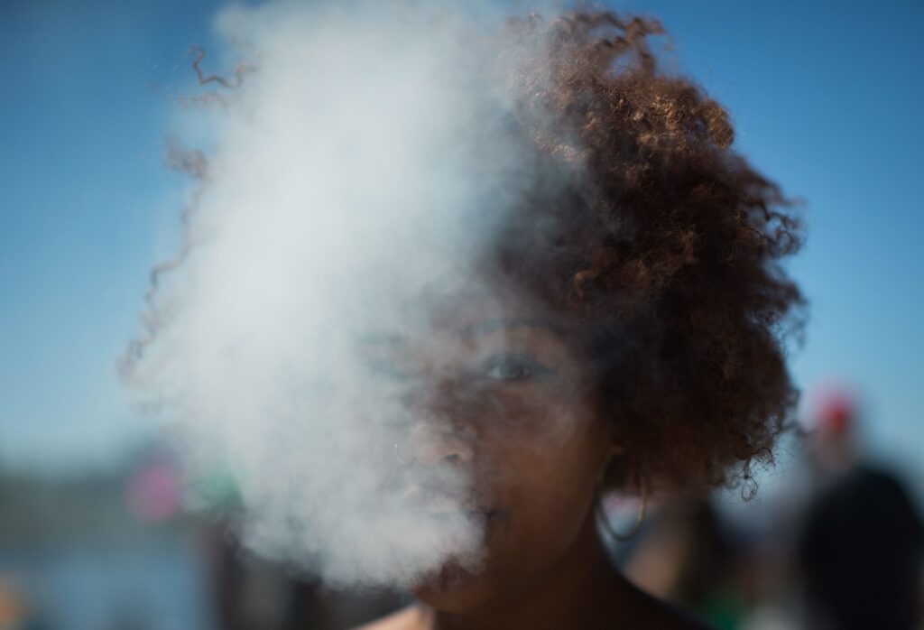 A woman exhales after taking a hit from a bong during 4/20, the annual day of celebration for cannabis culture lovers, at Sunset Beach in Vancouver, British Columbia, Wednesday April 20, 2016. Canada's health minister says legislation to legalize marijuana will be introduced next spring. (Darryl Dyck/The Canadian Press via AP) MANDATORY CREDIT