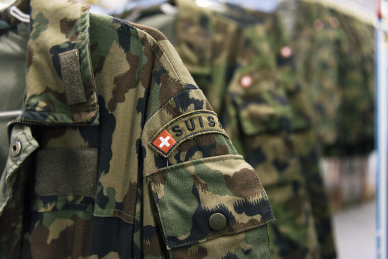 Camouflage clothing is hung on coathangers, checked and repaired at the textile center of the Swiss Armed Forces' logistics center in Thun, canton of Berne, Switzerland, on April 21, 2016. (KEYSTONE/Christian Beutler)