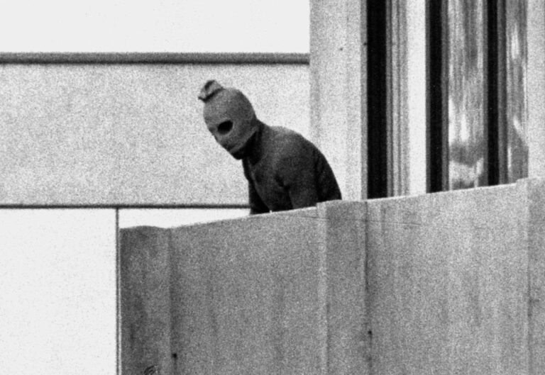 A member of the Arab Commando group which seized members of the Israeli Olympic Team at their quarters at the Munich Olympic Village September 5, 1972 appears with a hood over his face on the balcony of the village building where the commandos held several members of the Israeli team hostage. (KEYSTONE/AP Photo/Str)