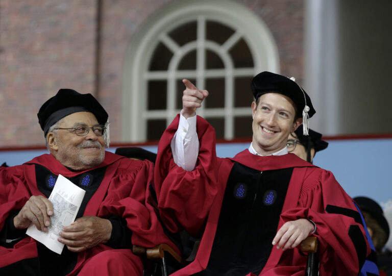 Facebook CEO and Harvard dropout Mark Zuckerberg, right, gestures as actor James Earl Jones, left, looks on while seated on stage during Harvard University commencement exercises, Thursday, May 25, 2017, in Cambridge, Mass. Zuckerberg was presented with an honorary Doctor of Laws degree Thursday and gave a commencement address at Harvard. (AP Photo/Steven Senne)