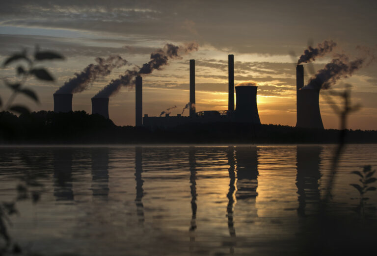 The coal-fired Plant Scherer, one of the nation's top carbon dioxide emitters, stands in the distance in Juliette, Ga., Saturday, June, 3, 2017. U.S. President Donald Trump declared Thursday he was pulling the U.S. from the landmark Paris climate agreement, striking a major blow to worldwide efforts to combat global warming and distancing the country from its closest allies abroad. (AP Photo/Branden Camp)