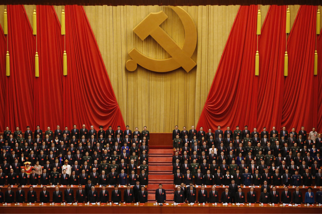 Chinese President Xi Jinping, front row center, stands with his cadres during the Communist song at the closing ceremony for the 19th Party Congress at the Great Hall of the People in Beijing, Tuesday, Oct. 24, 2017. (AP Photo/Andy Wong)