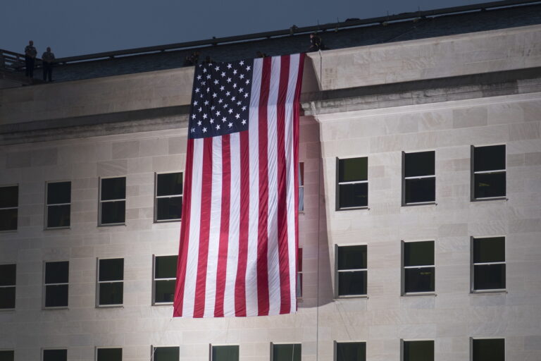 epa07012124 The US national flag is draped at the Pentagon building at dawn before the 17th anniversary 9/11 remembrance ceremony in Arlington, Virginia, USA, 11 September 2018. The ceremony commemorates the 184 people killed at the Pentagon when terrorists crashed an airliner into the building on 11 September 2001. EPA/MICHAEL REYNOLDS