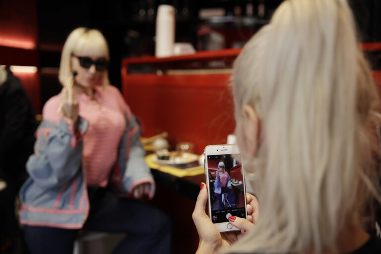 Customer Fashion blogger Clizia Incorvaia, right, takes pictures of her friend singer Vittoria Hyde as they have lunch at the 'This is not a Sushi bar' restaurant, in Milan, Italy, Tuesday, Oct. 16, 2018. Although this is the sixth restaurant the brand âÄœThis is not a sushi barâÄ opens in Milan, it has one key difference from its other locations: here payment can be made according to the number of Instagram followers one has, attracting big time social influencers and holders of smaller accounts alike. (AP Photo/Luca Bruno)