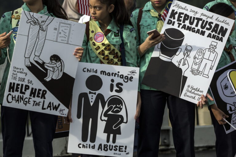 epa07161714 Activists hold placards as they gather outside the parliament building to hand over a memorandum and petitions to end child marriage in Kuala Lumpur, Malaysia, 13 November 2018. A group of activists and schoolchildren gathered outside the parliament building to handover a memorandum and a petition with 156,000 signatures to the government asking to end child marriage in the country. The issue came into light in July 2018 after a 41-year-old Malaysian man took an 11-year-old girl as his third wife. EPA/AHMAD YUSNI