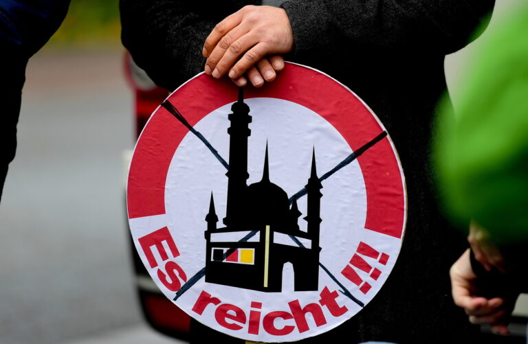 epa07162507 A sign 'It's enough!!!' during an anti-islam protest against construction of Thuringia's first mosque in Erfurt, Germany, 13 November 2018. Thuringia's first new mosque, to be built by Erfurt Ahmadiyya community, will cost a total of 600,000 euros and the money will be raised from a nationwide donations. EPA/FILIP SINGER