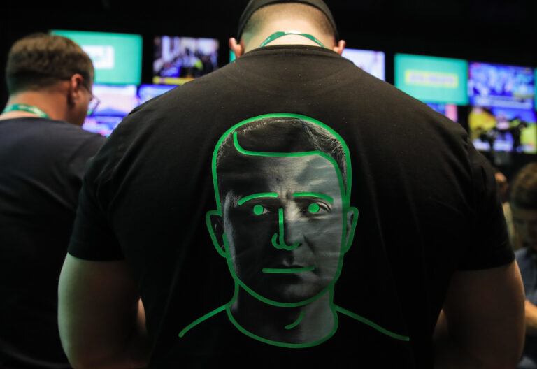 A man dressed in a shirt with a portrait of Ukrainian comedian and presidential candidate Volodymyr Zelenskiy waits for Zelenskiy's press conference after the end of voting in second round of presidential elections in Kiev, Ukraine, Sunday, April 21, 2019. Ukrainians voted on Sunday in a presidential runoff as the nation's incumbent leader struggles to fend off a strong challenge by a comedian who denounces corruption and plays the role of president in a TV sitcom. (AP Photo/Vadim Ghirda)