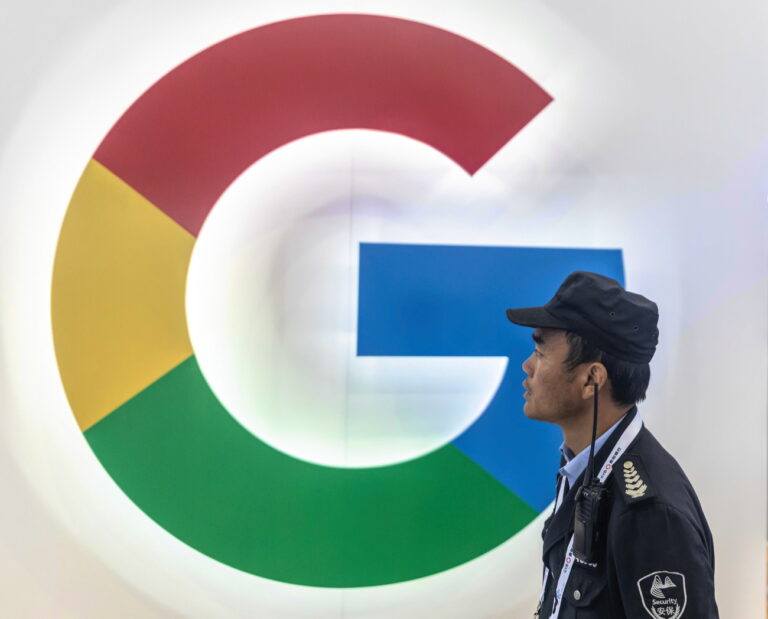 epa07602391 A security guard passes a Google booth during Big Data Expo in Guiyang, Guizhou province, China, 26 May 2019. The expo on big data opened on 26 May, incudes major Chinese companies and focuses on the latest innovations in technology and its applications. Guizhou province set up China's first big data pilot zone which has attracted companies such as Apple, Qualcomm, Huawei, Tencent, Alibaba and Foxconn. EPA/ALEKSANDAR PLAVEVSKI