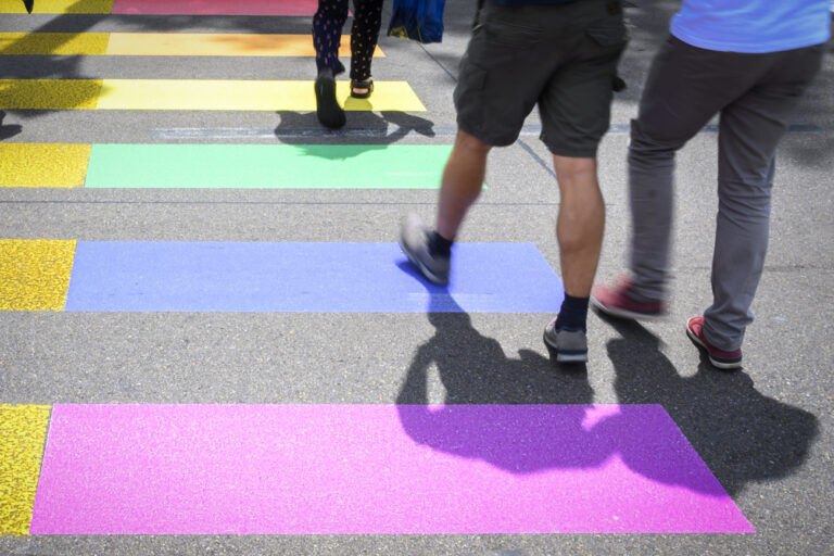 A pedestrian strip is painted in the colors of the rainbow, at the Gay Pride parade in Zurich, Switzerland, under the motto 