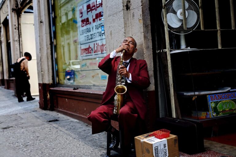 A blind musician, known as Don Tomas, plays the saxophone in a street of downtown Guatemala City, Friday, May 4, 2007. (AP Photo/Rodrigo Abd)