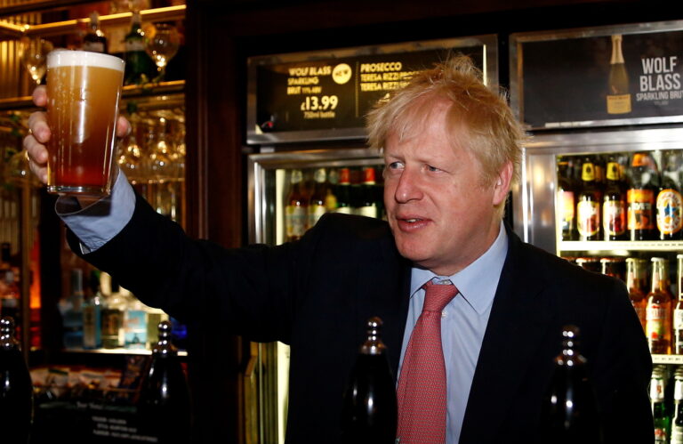 epa07707288 Boris Johnson, a leadership candidate for Britain's Conservative Party, holds a beer during his meeting with JD Wetherspoon chairman Tim Martin at Wetherspoons Metropolitan Bar in London, Britain, 10 July 2019. The Conservative Party is expected to announce its new leader on 23 July after Prime Minister Theresa May announced her resignation on 07 June. EPA/Henry Nicholls / POOL