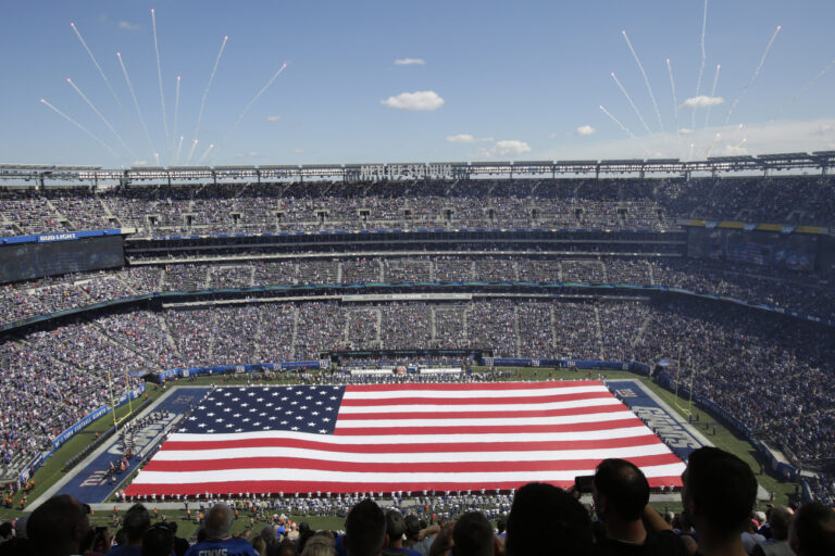 A large flag is unfurled before an NFL football game between the New York Giants and the Buffalo Bills, Sunday, Sept. 15, 2019, in East Rutherford, N.J. (AP Photo/Adam Hunger)
