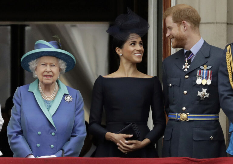 FILE - In this Tuesday, July 10, 2018 file photo Britain's Queen Elizabeth II, and Meghan the Duchess of Sussex and Prince Harry watch a flypast of Royal Air Force aircraft pass over Buckingham Palace in London. As part of a surprise announcement distancing themselves from the British royal family, Prince Harry and his wife Meghan declared they will âÄœwork to become financially independentâÄ _ a move that has not been clearly spelled out and could be fraught with obstacles. (AP Photo/Matt Dunham, File)