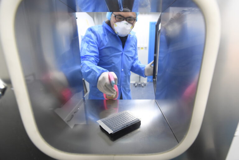 epa08199486 A staffer works in the pop-up Huoyan Laboratory specialized in the nucleic acid test on the novel coronavirus (2019-nCoV) in Wuhan, Hubei province, China, 06 February 2020 (issued 07 February 2020). The P2-level biosafety lab was built in five days, designed to perform 10,000 coronavirus tests per day to cope with the outbreak. The virus, which originated in the Chinese city of Wuhan, has so far killed at least 638 people and infected over 31,000 others, mostly in China. EPA/SHEPHERD ZHOU CHINA OUT