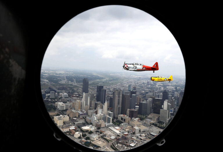 As seen from the portal of a vintage World War II era bomber, war aircraft from the Cavanaugh Flight Museum fly in a group over the city of Dallas Friday, May 22, 2020. The vintage warbirds flew over several medical facilities and other locations in a tribute they called 
