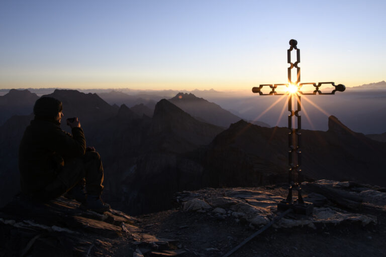 A man poses and drinks a hot tea during the Sunrise from the summit of the Grande Dent de Morcles (2'969m), above Morcles VD, Switzerland, this Tuesday, September 15, 2020. (KEYSTONE/Anthony Anex)