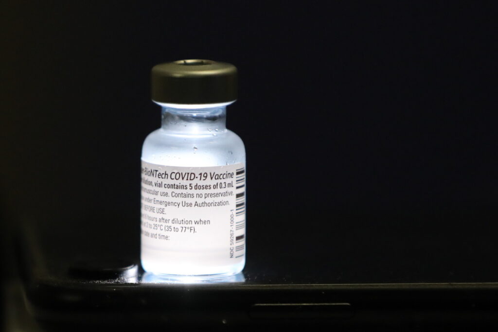 epa08895101 A detail view of a vial containing five doses of 0.3ml of the Pfizer-BioNTech COVID-19 vaccine at Shaare Zedek Medical Center in Jerusalem, Israel, 20 December 2020. Israel begins a nationwide COVID-19 vaccination campaign as hundreds of thousands of vaccines are delivered to hospitals across the country. First, the medical staff will be vaccinated and then people from high potential risk groups and the elderly population. Authorities hope to vaccinate as many people as possible. EPA/ABIR SULTAN