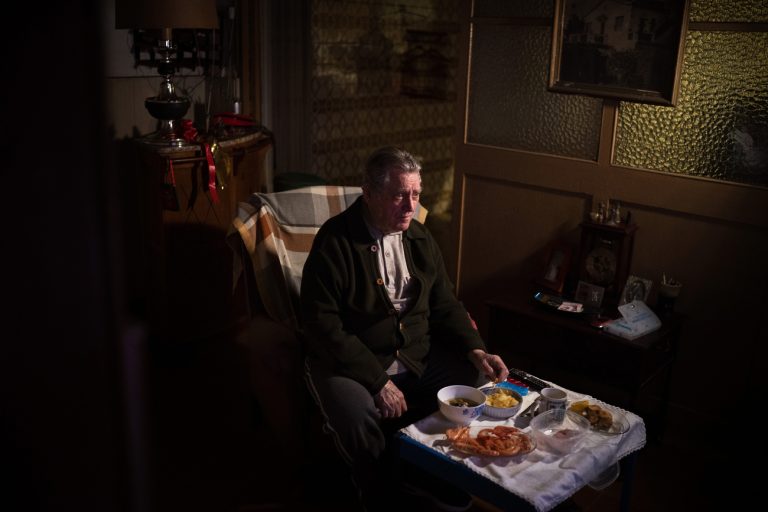 àlvaro Puig Moreno watches television while eating a his Christmas Eve dinner at his home in Barcelona, Spain, Thursday, Dec. 24, 2020. 