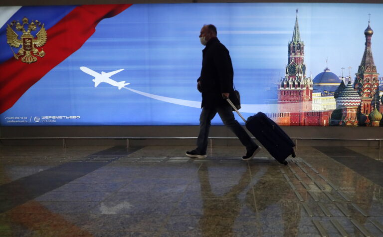 epa08942660 A man wearing a protective face mask walks at the Terminal D of the Sheremetyevo International Airport, during the pandemic of SARS-CoV-2 coronavirus in Moscow, Russia, 16 January 2021. EPA/MAXIM SHIPENKOV