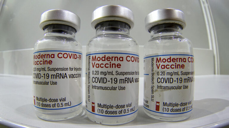 Three vials of the 'Moderna COVID-19 Vaccine' are pictured in a new coronavirus, COVID-19, vaccination center at the 'Velodrom' (velodrome-stadium) in Berlin, Germany, Wednesday, Feb. 17, 2021. (AP Photo/Michael Sohn, pool)