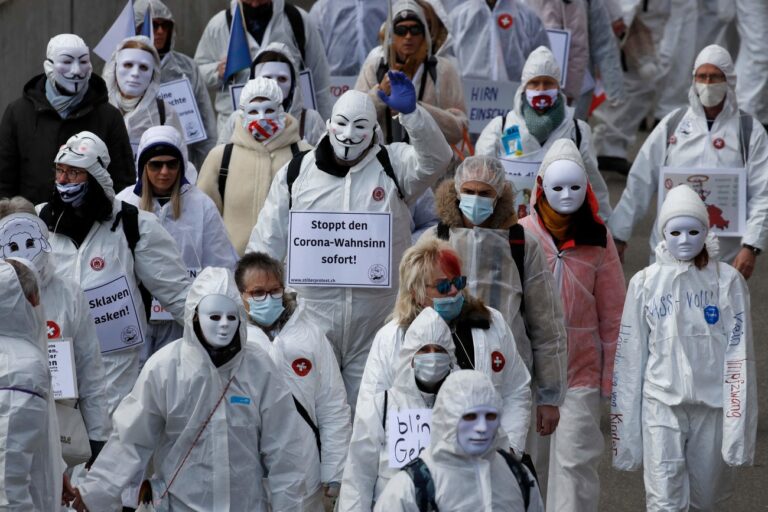 TO GO WITH AFP SPECIAL REPORT : Conspiracy epidemic, born in US, spreads in Europe (FILES) In this file photo taken on March 20, 2021 Protesters dressed in white take part in a demonstration against the ongoing coronavirus Covid-19 restrictions in Liestal, near Basel. - From The Hague to Stuttgart and Paris, they claim to be battling the control of their minds by a ruling class that invented the Covid-19 pandemic for its own ends, seeing themselves as promoting and disseminating alternative views from the official version..Conspiracy theories, driven by the global health crisis, are taking root in Europe more than ever, drawing inspiration from the QAnon movement in the United States. (Photo by STEFAN WERMUTH / AFP) (KEYSTONE/AFP/STEFAN WERMUTH)