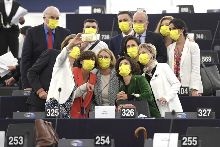 European Parliament members take pictures before the plenary session of the European Parliament in Strasbourg, eastern France, Monday June 7, 2021. The European Parliament holds its first session in Strasbourg since the beginning of the pandemic. (KEYSTONE/Frederick Florin, Pool via AP)