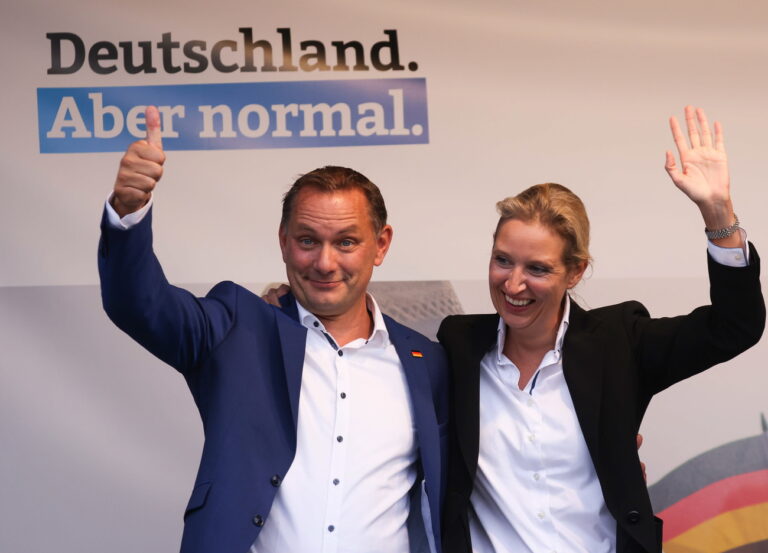 epa09408693 Alternative for Germany party (AfD) deputy chairwoman and top candidate for the upcoming federal elections Alice Weidel (R) and Alternative for Germany party (AfD) co-chairman and top candidate for the upcoming federal elections Tino Chrupalla wave as they attend a rally of the AfD party for the campaign start for the federal elections in Schwerin, Germany, 10 August 2021. The AfD is starting their election campaign on 10 August 2021 in the east German town of Schwerin. The federal German elections will be held on 26 September 2021. EPA/FILIP SINGER