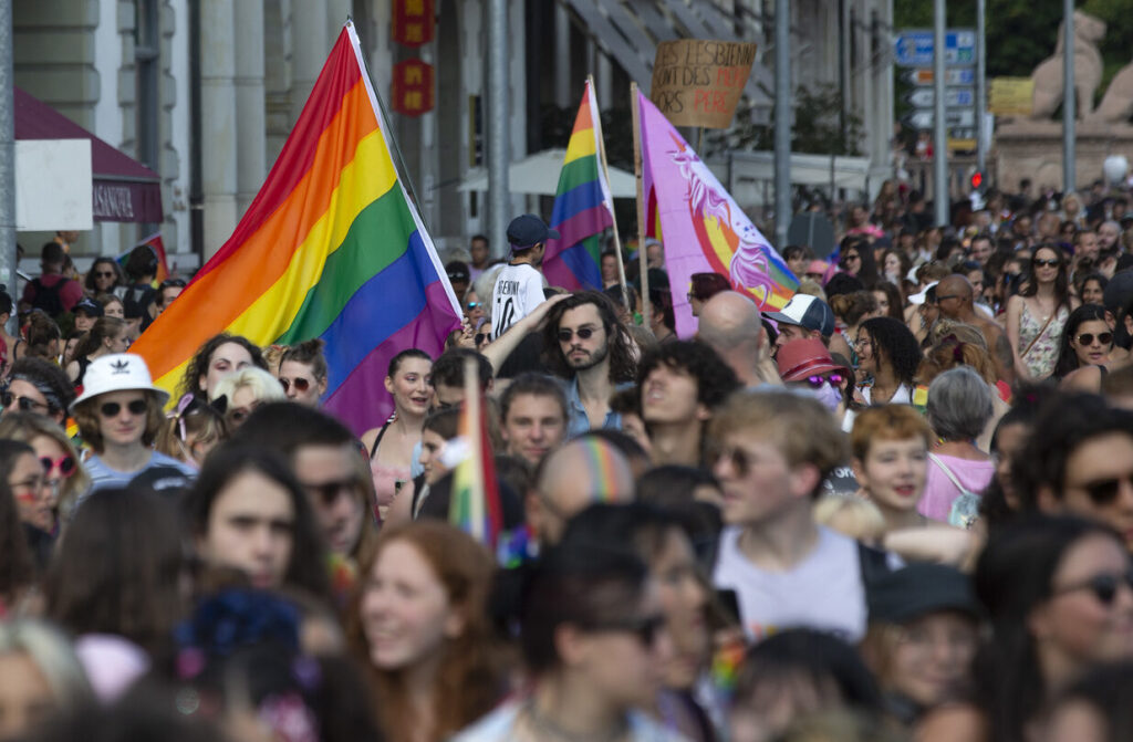 People walk through the streets for the rights of the LGBTIQ+ community during the Geneva Pride march, in Geneva, Switzerland, Saturday, September 11, 2021. (KEYSTONE/Salvatore Di Nolfi)
