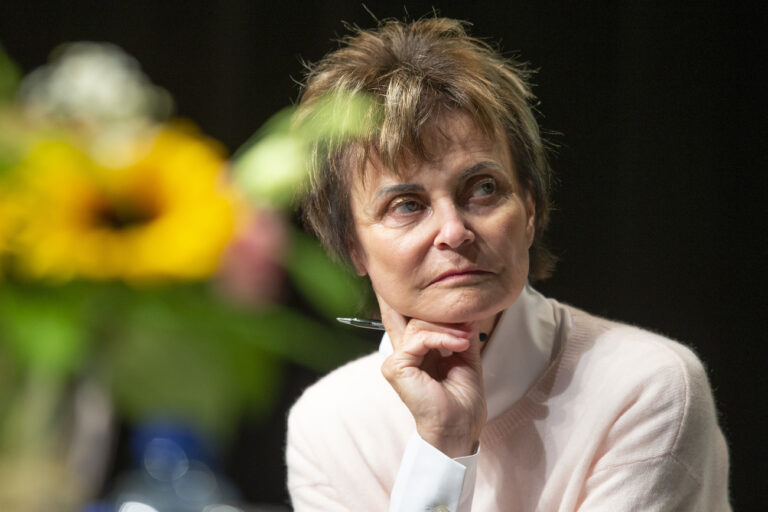 Former Swiss President Micheline Calmy-Rey listens a speech during the dialogue around of 