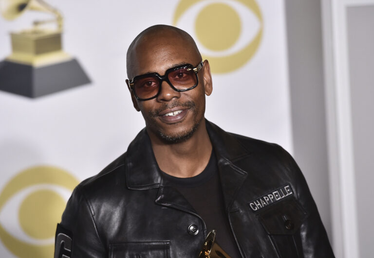 FILE - In this Jan. 28, 2018 file photo, Dave Chappelle poses in the press room with the best comedy album award for 