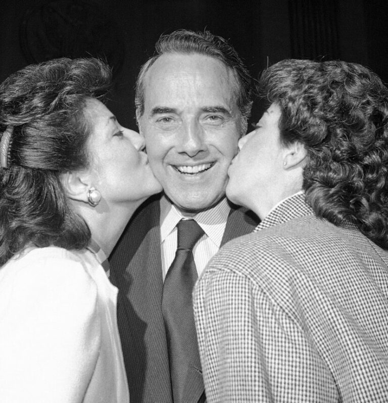 FILE - In this Nov. 28, 1984, file photo, newly elected Senate Majority Leader Dole, of Kansas, is kissed by his wife, Transportation Secretary Elizabeth Dole and his daughter, Robin, on Capitol Hill in Washington. Bob Dole, who overcame disabling war wounds to become a sharp-tongued Senate leader from Kansas, a Republican presidential candidate and then a symbol and celebrant of his dwindling generation of World War II veterans, has died. He was 98. His wife, Elizabeth Dole, posted the announcement Sunday, Dec. 5, 2021, on Twitter. (AP Photo/Ira Schwarz, File)